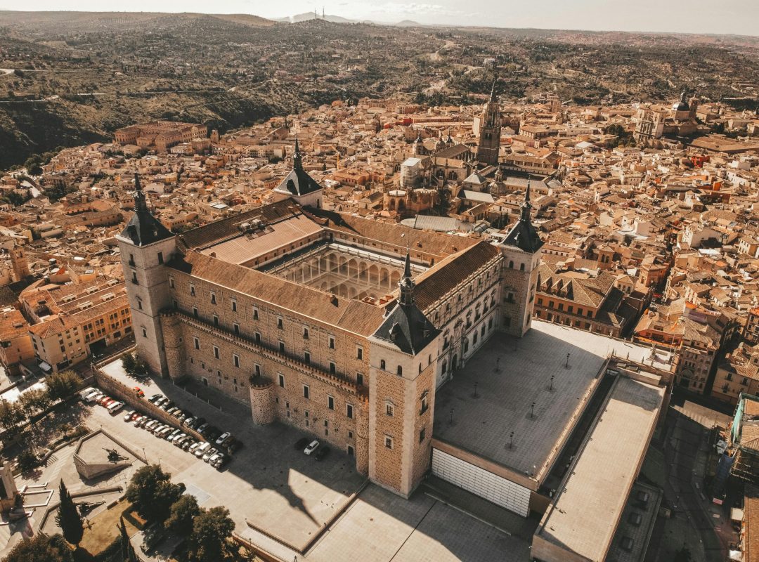 Stunning aerial view of Alcázar of Toledo, showcasing historic architecture and cityscape in Spain.